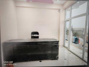 a black briefcase in a room with a window at Hotel O Surya Hotel in Kākori
