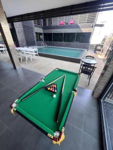 a pool table sitting on a patio with a swimming pool at Nangfa Mini Hotel in Ban Pa Kwao +124 photos