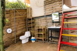 a bathroom with a toilet and a sink at Danny Glamping Farm in Bao Loc +58 photos