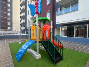 a playground in front of a building with a slide at Apartamento Familiar en Sabaneta cerca al parque in Sabaneta