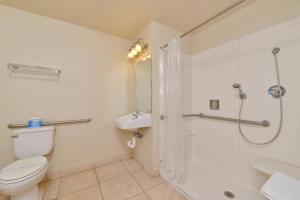 a bathroom with a toilet and a shower at Rodeway Inn Stockton Highway 99 in Stockton
