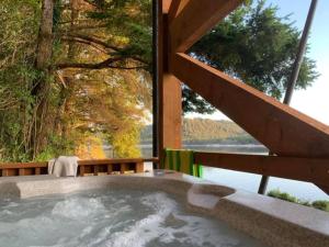 a jacuzzi tub with a view of the water at Stunning Beachfront Cabin with Barbecue and Hot-tub in Otis, Oregon in Three Rocks