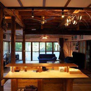 a living room with a large wooden table at つなぎ in Nishiwaga