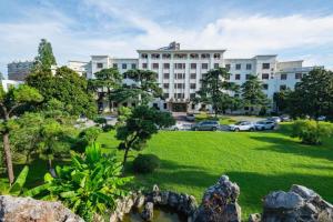 a large building with a park in front of it at Jin Jiang Nanjing Hotel in Nanjing