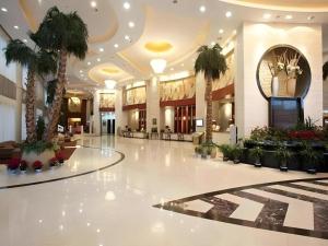 a large lobby with palm trees in a building at Dunhuang Grand Soluxe Hotel in Dunhuang +222 photos