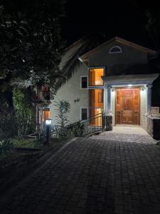 a house with a brick walkway leading to a wooden door at Dafrican BnB villa in Kigali +29 photos