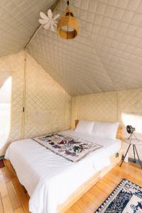 a bedroom with a bed in a tent at Danny Glamping Farm in Bao Loc