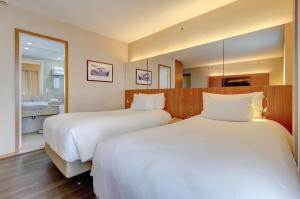 Ένα ή περισσότερα κρεβάτια σε δωμάτιο στο Radisson Blu São Paulo