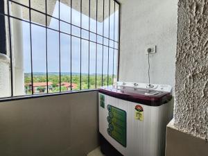 a room with a sink and a large window at Ultra Luxe 2BHK Candolim Service Apartment with River and Mangrove Views in Candolim +22 photos