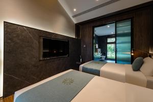 Ένα ή περισσότερα κρεβάτια σε δωμάτιο στο Huazhu Luxury Tai'an Lile and Xiyuan +114 φωτογραφίες