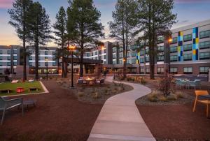 a park with tables and benches and a building at Tru By Hilton Flagstaff in Flagstaff