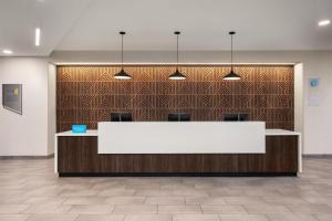 a lobby with a white reception desk in a building at Tru By Hilton Flagstaff in Flagstaff +46 photos