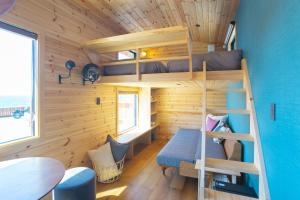 a tiny house with a bunk bed and a desk at Lady Blue伊豆稲取 in Higashiizu