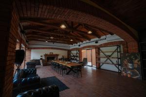 a large room with a wooden table and chairs at Mikheili's Marani Boutique Hotel in Kvareli +78 photos