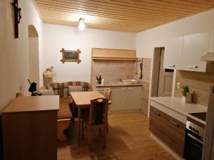 a kitchen and living room with a table in it at Hause Alpina in Bichlbach
