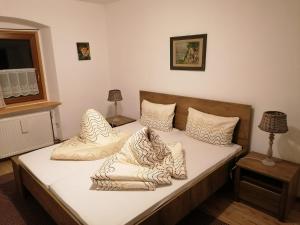 a bed with pillows on it in a room at Hause Alpina in Bichlbach