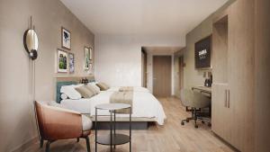 a bedroom with a bed and a desk and a table at Cambria Hotel Euless - DFW Airport South in Euless