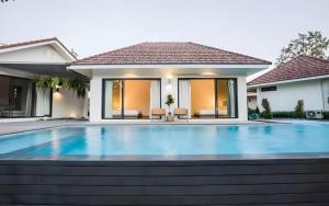 a swimming pool in front of a house at The Scandic Khao Yai in Ban Khanong Phra Klang (1)