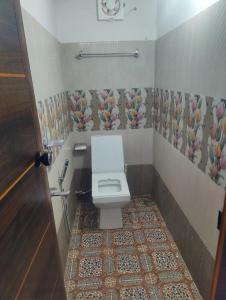 a bathroom with a toilet and a tile floor at Cuba beach villa in Alleppey +13 photos