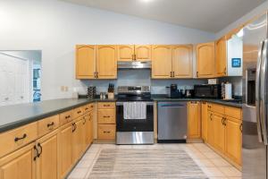 a kitchen with wooden cabinets and stainless steel appliances at New to listing Dorsey Dock Retreat w Dock in Hartwell
