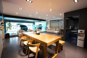a kitchen and living room with a wooden table and chairs at Infinite Hotel-Ratchada in Bangkok