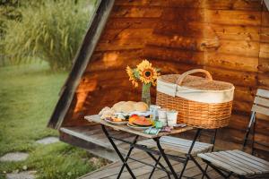 a picnic table with a basket and food on it at Glamping Bizjak in Preddvor +44 photos
