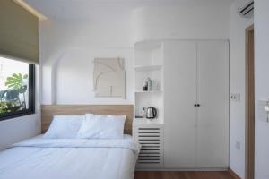 Ένα ή περισσότερα κρεβάτια σε δωμάτιο στο Adory Homestay Huế