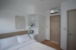 Ένα ή περισσότερα κρεβάτια σε δωμάτιο στο Adory Homestay Huế