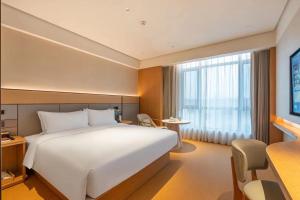 Ένα ή περισσότερα κρεβάτια σε δωμάτιο στο JI Hotel Beijing Changping Future Science City