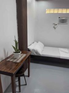 a small room with a table and a bed at Bergon Homestay in Burgos