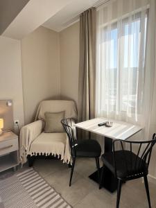 a small room with a table and chairs and a window at Daily-Weekly-Monthly in Kötekli Center 