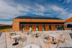 a patio with tables and chairs in front of a building at Wine & boutique hotel Terbotz in Štrigova