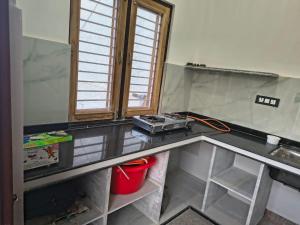 a kitchen with a counter top and a window at C-57, Nitin khandelwal in Jaipur
