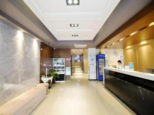 een lobby met een bank in het midden van een gebouw bij Jinjiang Inn Tai'an Taishan Railway Station in Tai'an