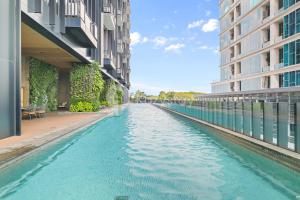 a waterway between two buildings in a city at Minori by Kozystay - Alam Sutera in Dongkal Dua