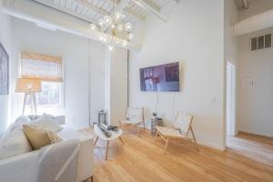 a white living room with a couch and chairs at Darlin Downtown Dawghouse in Athens