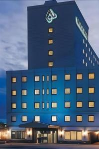 a blue building with a sign on top of it at Albert Hotel in Dote-nagamachi