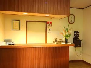 a lobby with a reception counter with flowers on it at Yumekiko in Nasushiobara
