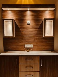 a kitchen with a counter and a wooden wall at Urban Retreat in Agra