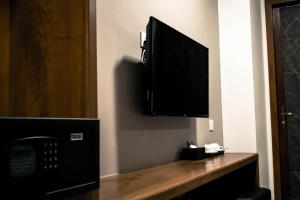a flat screen tv hanging on a wall at Point Boutique Hotel in Phnom Penh