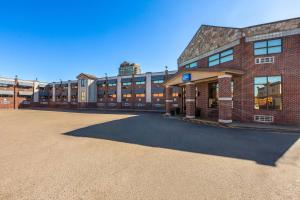 an empty parking lot in front of a brick building at Baymont by Wyndham Downtown Detroit in Detroit