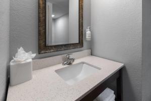 a bathroom with a sink and a mirror at Baymont by Wyndham Downtown Detroit in Detroit +22 photos