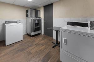 a room with a kitchen with a counter and appliances at Baymont by Wyndham Downtown Detroit in Detroit