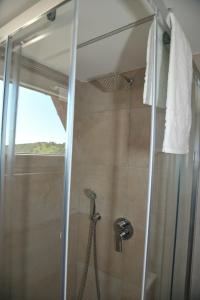 a shower with a glass door in a bathroom at Alla Quercia in Monterotondo