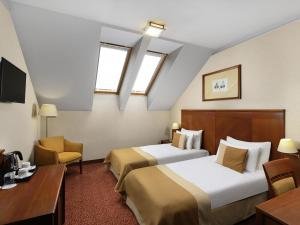 Ένα ή περισσότερα κρεβάτια σε δωμάτιο στο Mercure Szekesfehervar Magyar Kiraly +131 φωτογραφίες