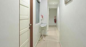 a hallway with a door and a chair in a room at Swing & Pillows @ PJ KD in Sungai Way +48 photos