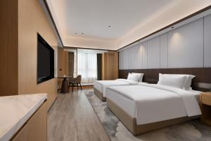 Postel nebo postele na pokoji v ubytování Wanda Moments Neo, Shijiazhuang Chang'an