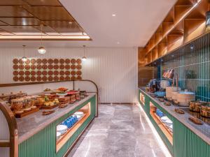 a kitchen with a buffet with food on display at Orange Hotel Beijing South Railway Station South Square in Beijing
