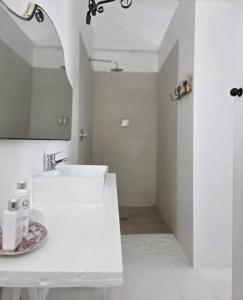 a white bathroom with a sink and a mirror at Stay at Richmond in Richmond