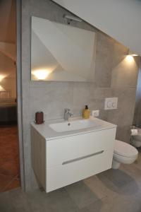 a bathroom with a white sink and a toilet at Alla Quercia in Monterotondo
